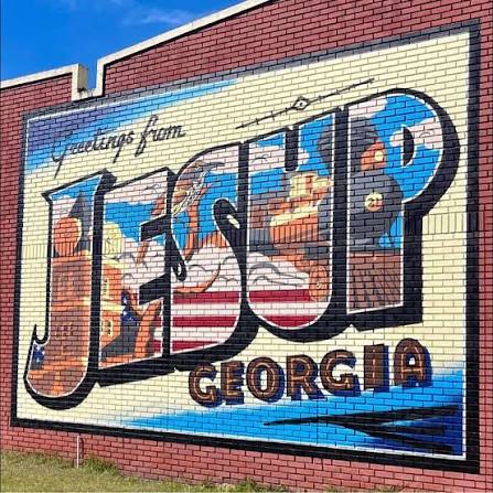 Downtown Jesup, Georgia, "postcard" style mural on red brick wall. 